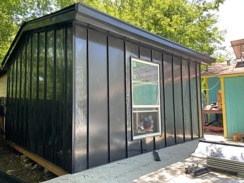 Black standing seam metal wall panels for Metal Roof Installation in Cushing